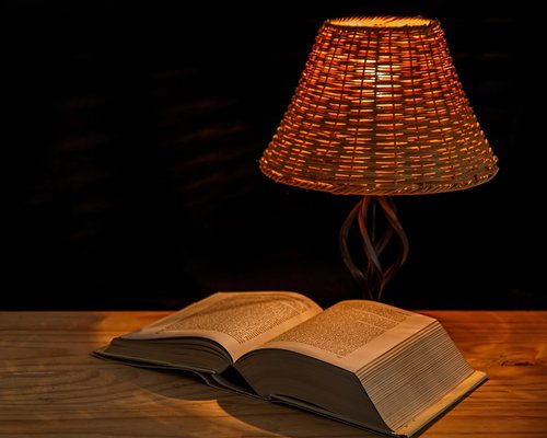 Warm reading lamp on a bedside table